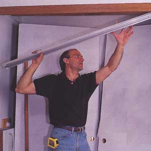 Unscrewing the metal door track