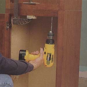 fasten the 12-in.-deep wall cabinet to the bookcase unit 