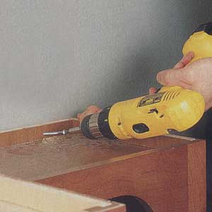 attach the cabinets to the wall