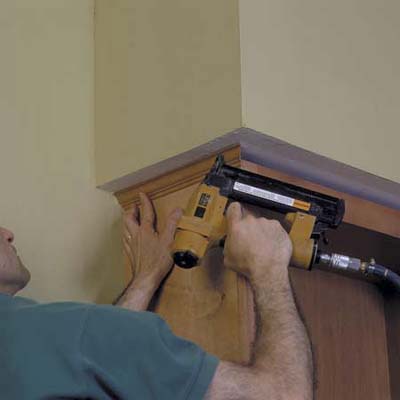 install finishing crown to top of cabinet unit