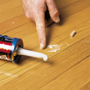 construction adhesive on a wood floor