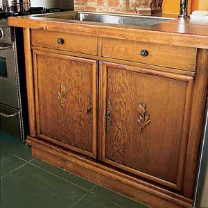1920s wood cabinets with carved details and elkay sink