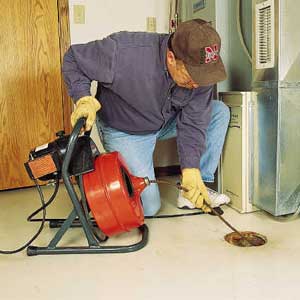 Photo 8: A POWER auger can break up the toughest clogs. Some models come with interchangeable cutting blades.