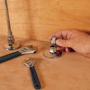 Use a wrench to loosen the water-supply tube from the adapter.