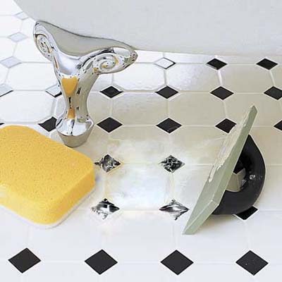 Swiping grout into the joints with a rubber grout float 