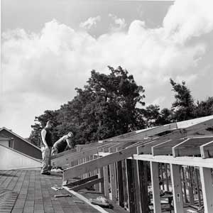 men survey their work on teh roof top