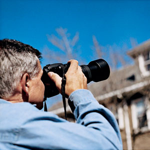 Tom Silva examines the roof during fall house inspection of East Boston project house