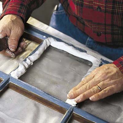 applying putty to exposed rabbets