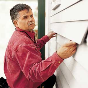 Tom Silva slips new clapboard