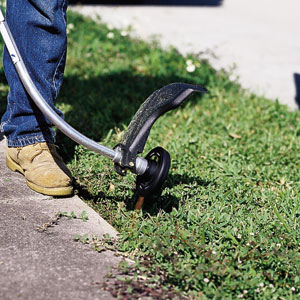 Cuttiing overgrown grass with a  string trimmer