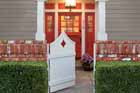 highly styled entry way with red painted door