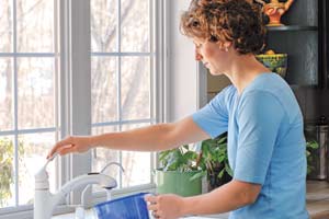 Woman at Sink in Kitchen