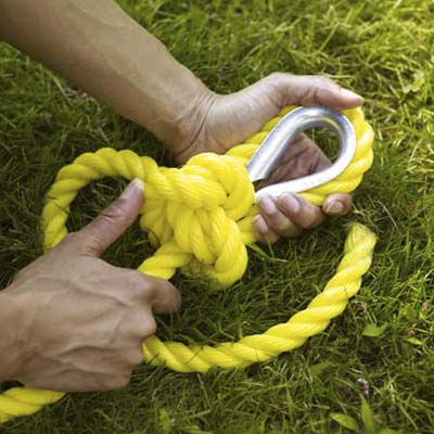 tying a secure knot to attach the rope that will hold up the swing