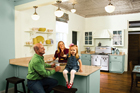 remodeled kitchen from an 1850s cottage with couple and young daughter