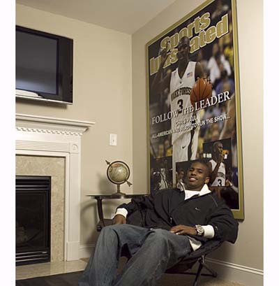 NBA star Chris Paul next to his fireplace