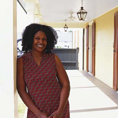 homeowner rashida ferdinand stands in front of her new house