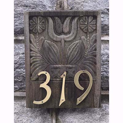 Brass numbers mounted on antique wooden mold