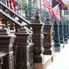 Cast-iron newel posts punctuate a lane of rowhouses.