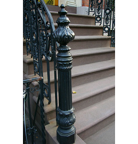 Stairs doused in ornamental cast-iron detail.