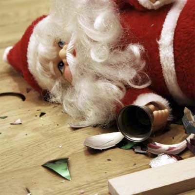santa ornament lying on the floor amidst various broken ornaments
