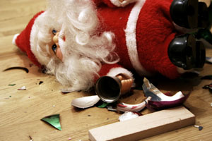 santa ornament lying on the floor amidst other broken ornament pieces