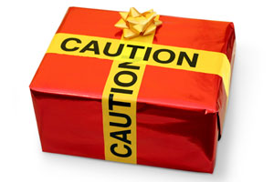 gift box wrapped with caution tape as a ribbon