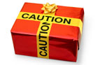 gift box wrapped with caution tape as a ribbon
