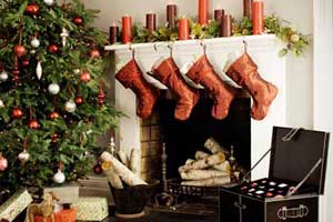 xmas tree, stockings over mantel and holiday decoration storage chest