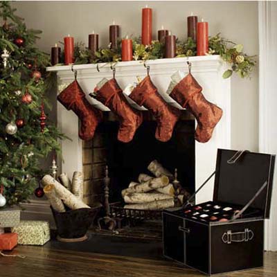 holiday ornament storage chest in living room with christmas tree, and decorated mantle