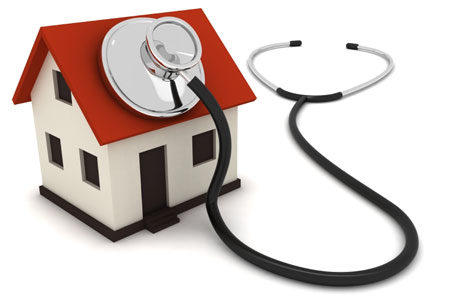 model house with stethoscope resting on the roof