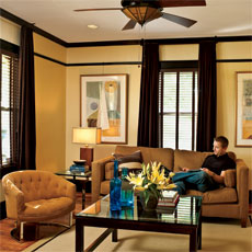 homeowner reading on a couch in his remodeled bungalow's living room