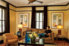 homeowner reading on a couch in his remodeled bungalow's living room
