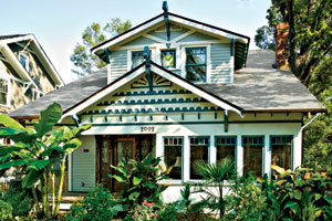 white and green exterior of the remodeled craftsman bungalow