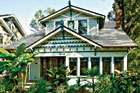 white and green exterior of the remodeled craftsman bungalow
