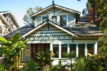white and green exterior of the remodeled craftsman bungalow