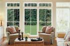 large windowed doors looking out from a living room onto a lawn