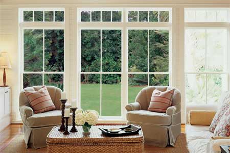 large windowed doors looking out from a living room onto a lawn
