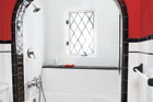 a Tudor-style renovated bath focusing on the shower alcove