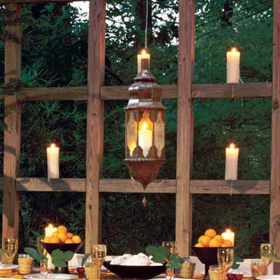dining table on deck with grid candle wall
