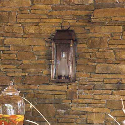 hanging candlelit lantern on outdoor wall