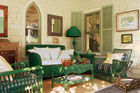 a porch filled with wicker furniture and rustic accents