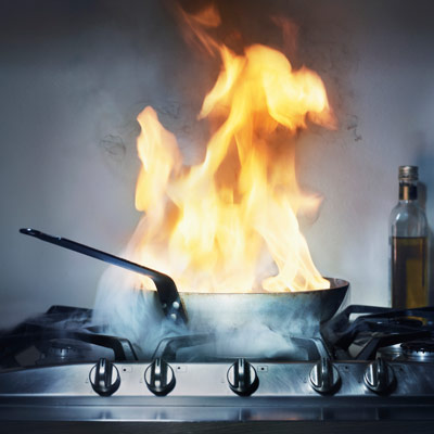 hazards in kitchen. kitchen fire with pot on gas