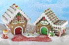 a pair of gingerbread houses with Santa and Frosty against a blue sky background