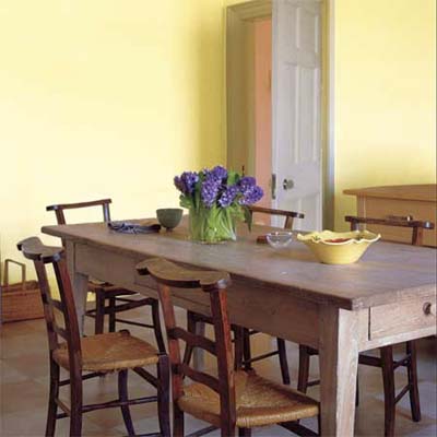 rustic limed table set in a dining room area
