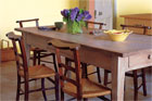 rustic limed looking table in a dining room