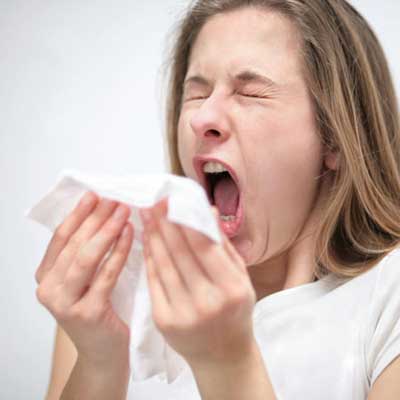 woman sneezing