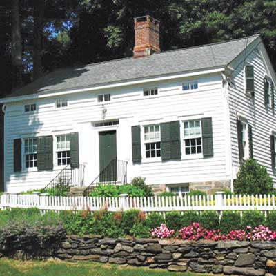 exterior of white saltbox home with wide siding