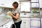 woman folding towels in spa laundry room