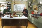 couple stands behind the island in their newly redesigned Georgian kitchen