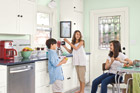 three kids laughing in remodeled vintage cafeteria kitchen